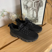 Sorte slip-on-sko med strikket overdel