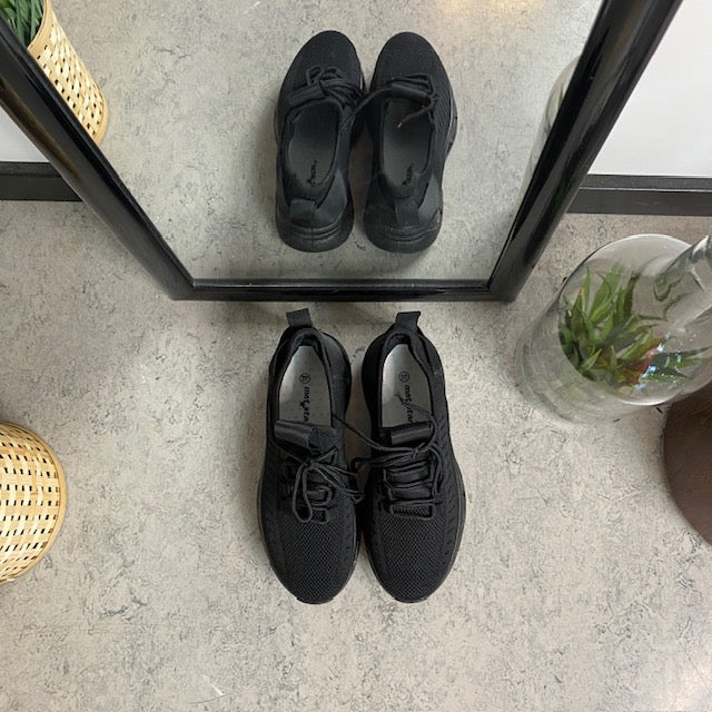 Sorte slip-on-sko med strikket overdel